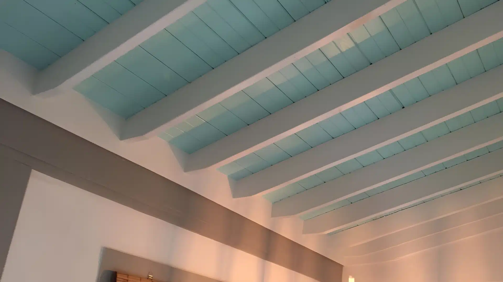 Beadboard panels interior ceiling with painted light blue planks and white beams