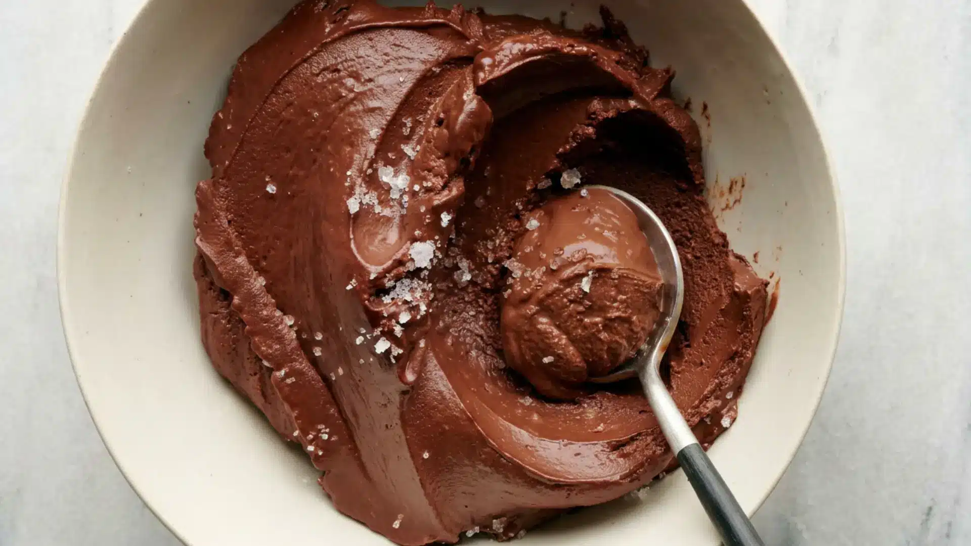 rich dark chocolate mousse served in a bowl with sea salt