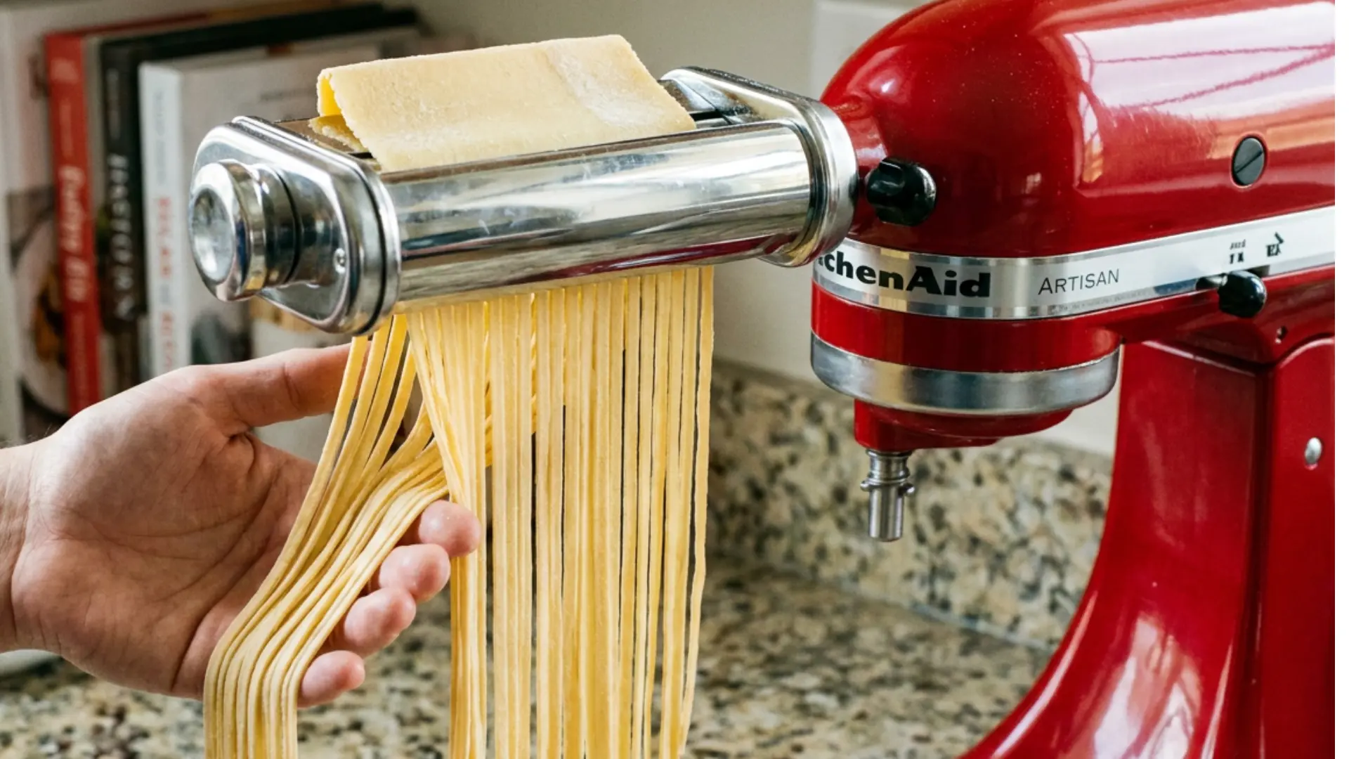 homemade pasta recipe fresh tagliatelle coming out of a red pasta machine