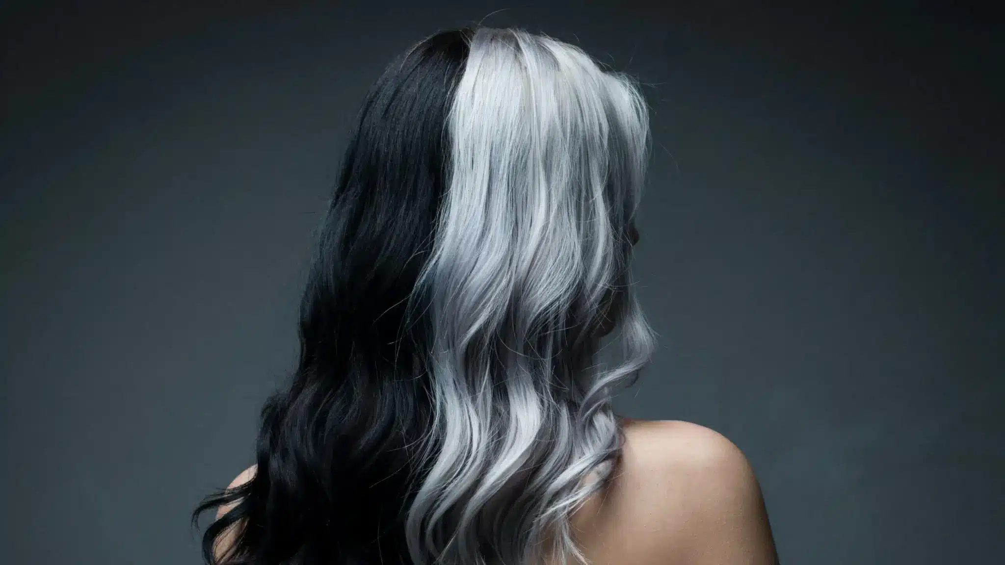 A woman embracing her split dye hairstyle in the image.