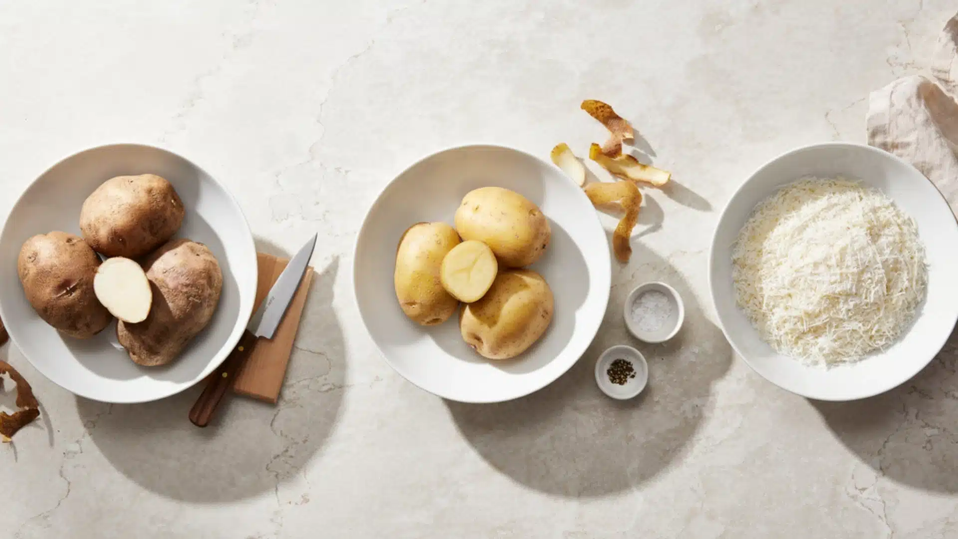 Three plates displaying a variety of potatoes one with russet potatoes, another with yukon golds potatoes , and a third with harsh brown potatoes.