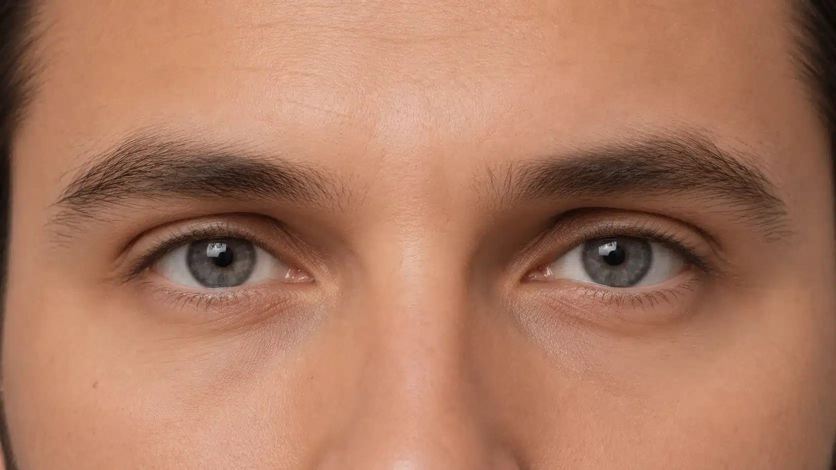 Close-up of a man's face showcasing deep-set blue eyes and defined facial features.