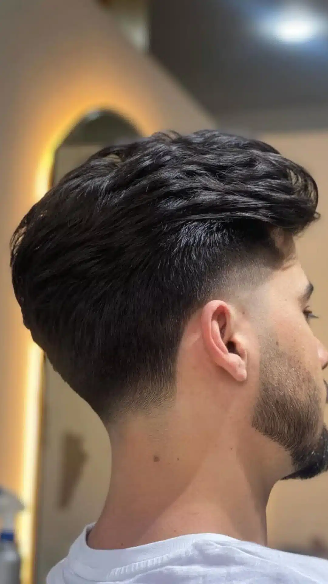 Side profile of a man with a classic taper haircut