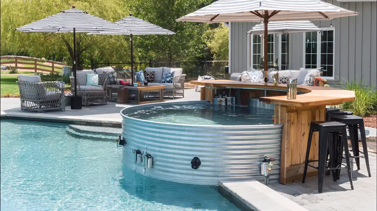 Stock tank pool with a built in bar and shaded seating area beside a backyard swimming pool